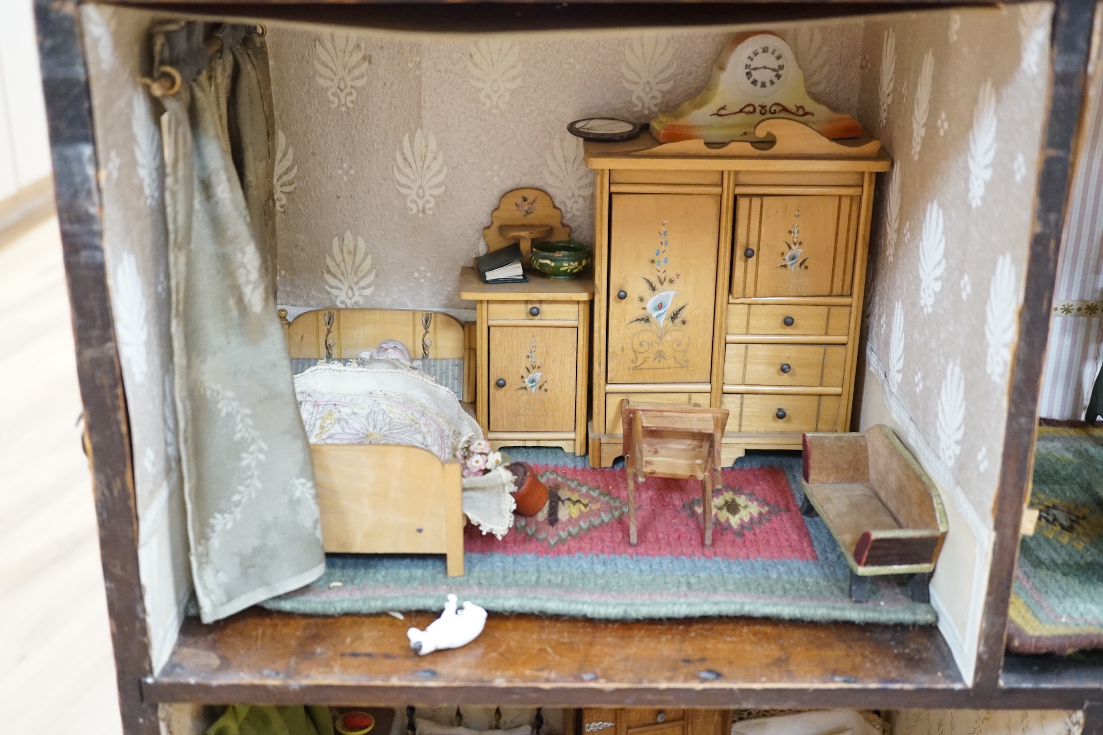 A furnished English dolls’ house, circa 1810-20, 104cm high